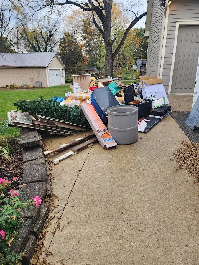 Dumpster being loaded with debris for 12 Yard Dumpster Rental in Lyon